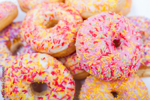 Donuts or Doughnuts With Colorful Frosting and Sprinkles