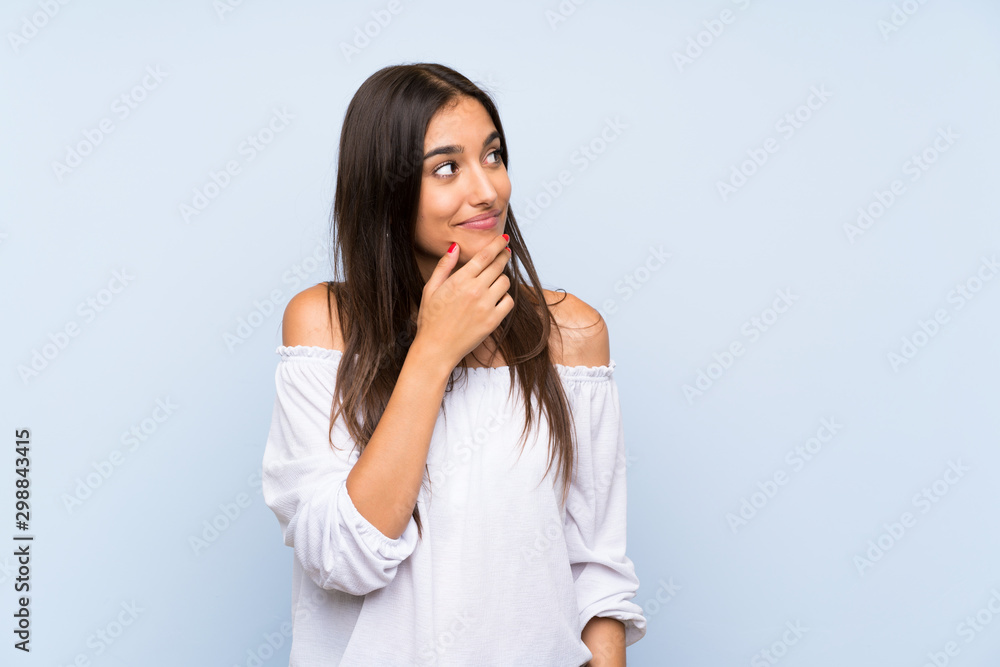 Young woman over isolated blue background thinking an idea Young woman over isolated blue background thinking an idea