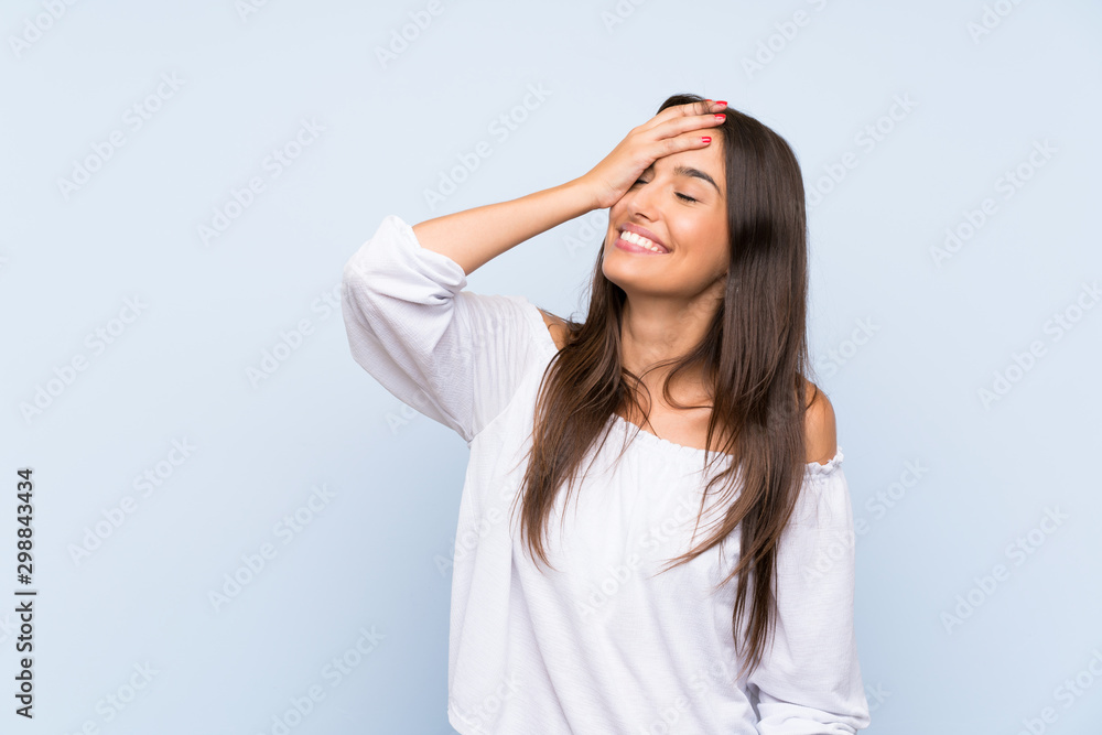 Young woman over isolated blue background laughing Young woman over isolated blue background laughing