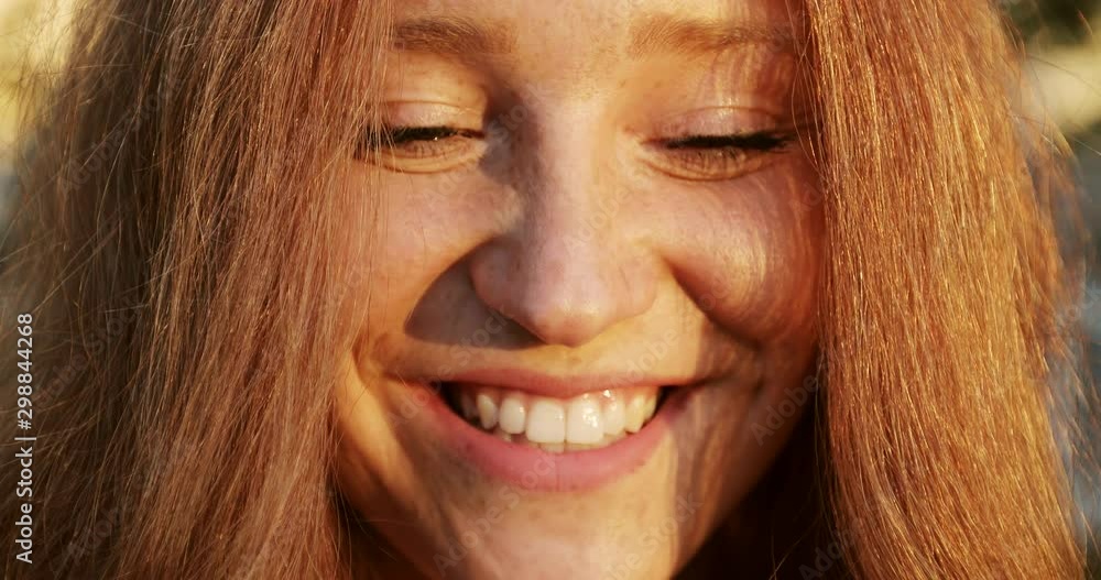 Close up happy girl face with red curly hair at sunset. Close up happy girl face with red curly hair at sunset.