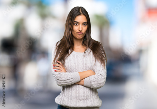 Young hispanic brunette woman feeling upset at outdoors