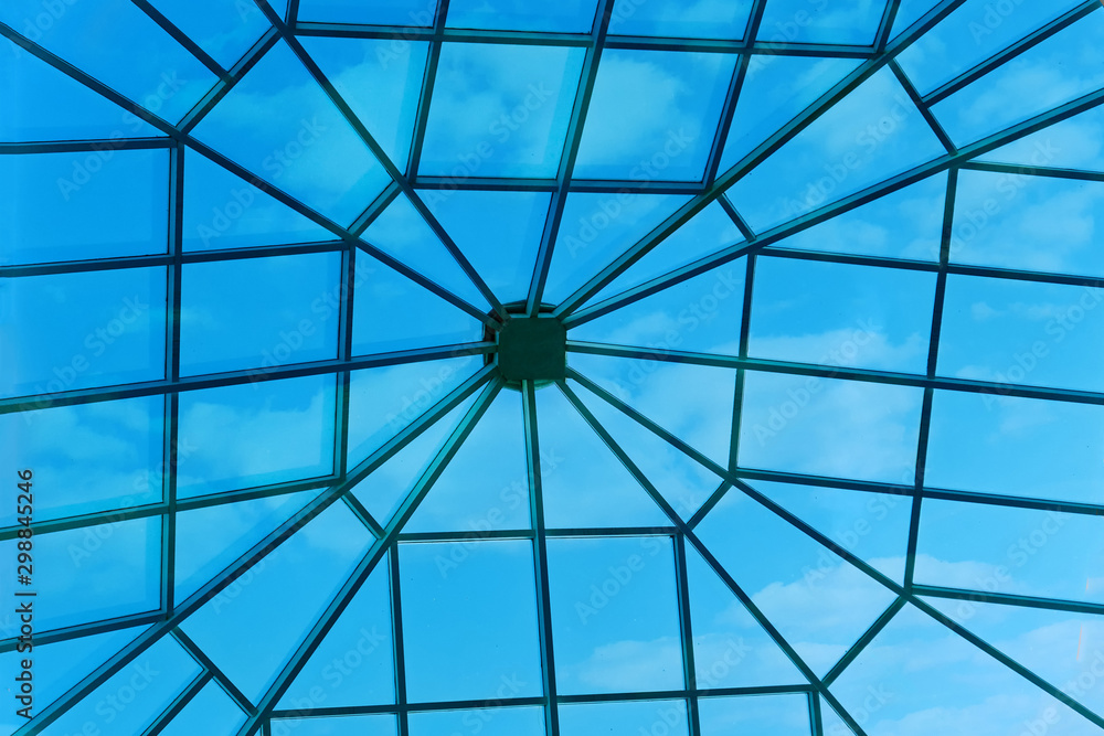 Large window in the roof of the hotel. Sky through a square window in the ceiling of the building.