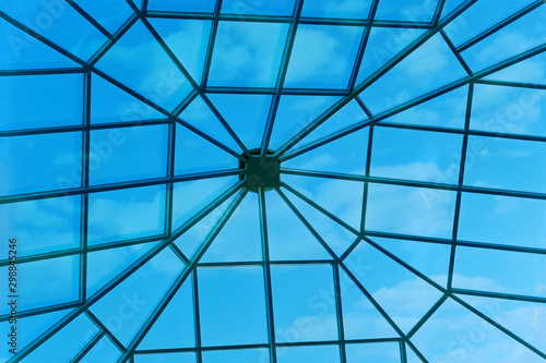 Large window in the roof of the hotel. Sky through a square window in the ceiling of the building.