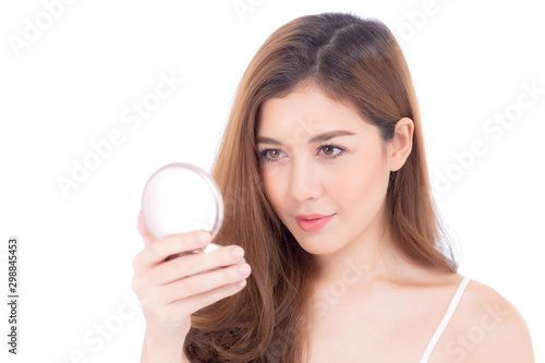 Portrait of beautiful asian woman applying powder puff at cheek makeup of cosmetic, beauty of girl with face smile isolated on white background, wellness and healthcare concept.