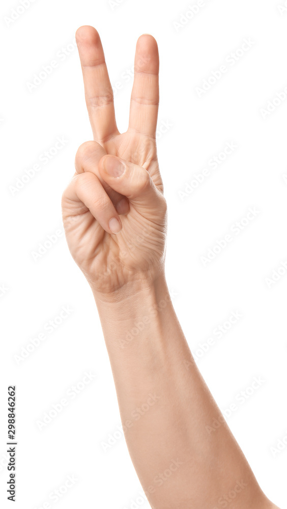 Hand of woman showing victory gesture on white background Hand of woman showing victory gesture on white background