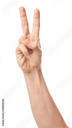 Hand of woman showing victory gesture on white background