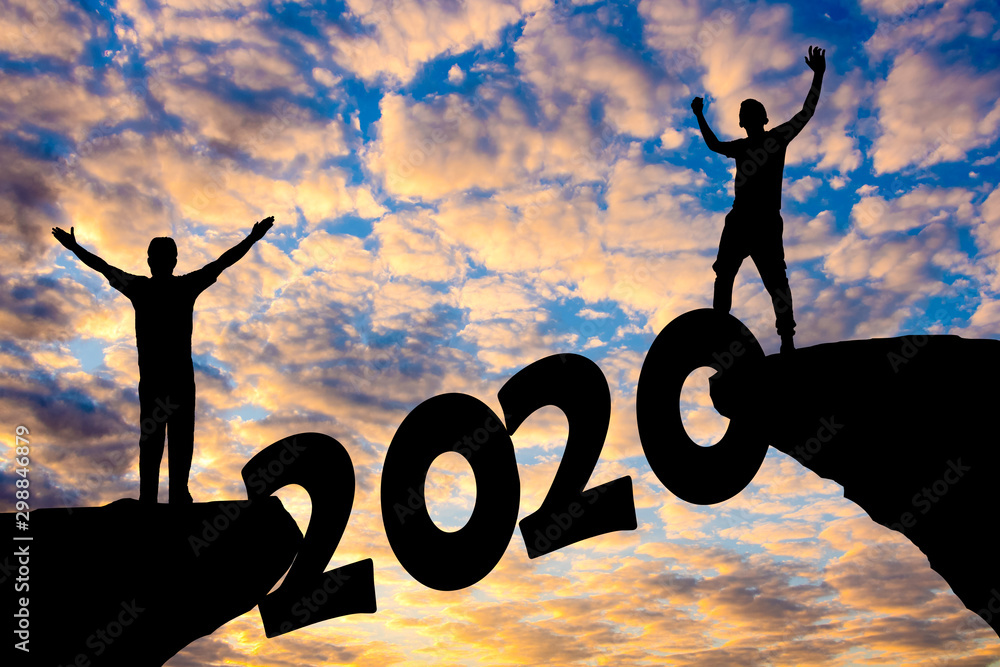 Happy new year Silhouette sunset background.A man and woman standing on cliff.They are standing beside 2019 word. new year, success,2019, Photo Silhouette and new year concept idea. Happy new year Silhouette sunset background.A man and woman standing on cliff.They are standing beside 2019 word. new year, success,2019, Photo Silhouette and new year concept idea.