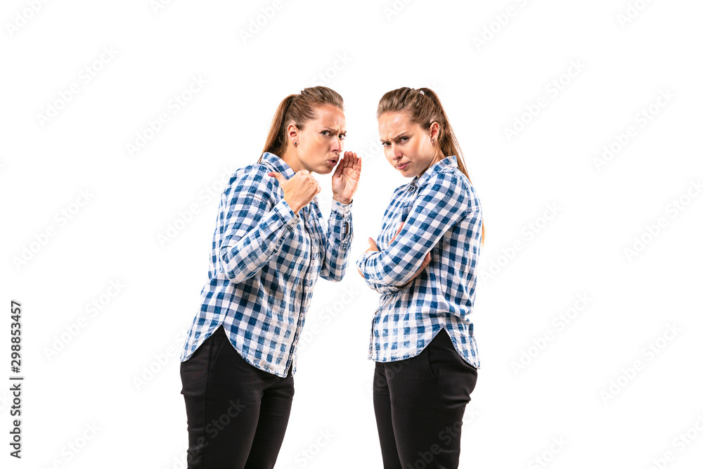 Young handsome woman arguing with herself on white studio background. Concept of human emotions, expression, mental issues, internal conflict, split personality. Half-length portrait. Negative space. Young handsome woman arguing with herself on white studio background. Concept of human emotions, expression, mental issues, internal conflict, split personality. Half-length portrait. Negative space.
