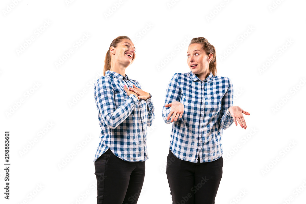Young handsome woman arguing with herself on white studio background. Concept of human emotions, expression, mental issues, internal conflict, split personality. Half-length portrait. Negative space. Young handsome woman arguing with herself on white studio background. Concept of human emotions, expression, mental issues, internal conflict, split personality. Half-length portrait. Negative space.