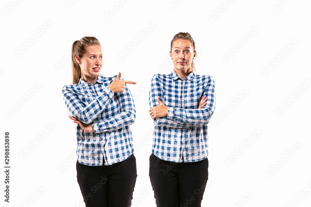 Young handsome woman arguing with herself on white studio background. Concept of human emotions, expression, mental issues, internal conflict, split personality. Half-length portrait. Negative space. Young handsome woman arguing with herself on white studio background. Concept of human emotions, expression, mental issues, internal conflict, split personality. Half-length portrait. Negative space.