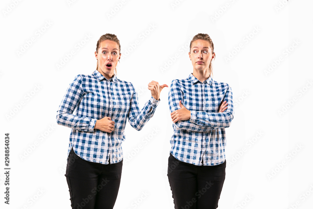 Young handsome woman arguing with herself on white studio background. Concept of human emotions, expression, mental issues, internal conflict, split personality. Half-length portrait. Negative space. Young handsome woman arguing with herself on white studio background. Concept of human emotions, expression, mental issues, internal conflict, split personality. Half-length portrait. Negative space.
