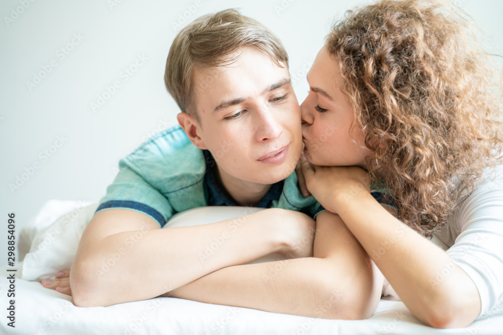 Close up portrait face of love couple lying on bed together Close up portrait face of love couple lying on bed together