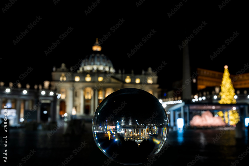 Fototapeta premium view of St. Peter ( San Pietro ) through a crystal ball, Rome at night
