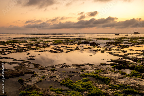 Seascape. Sunset at the beach. Ocean low tide. Horizontal background banner. Nyang Nyang beach, Bali, Indonesia.