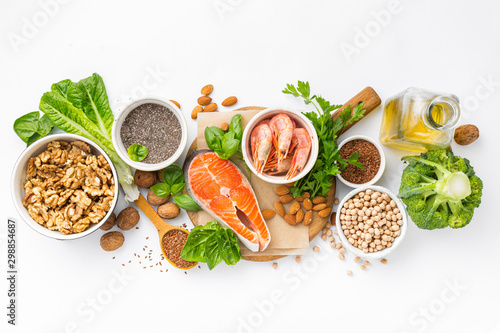 Food sources of omega 3 and omega 6 on white background top view. Foods high in fatty acids including vegetables, seafood, nut and seeds photo