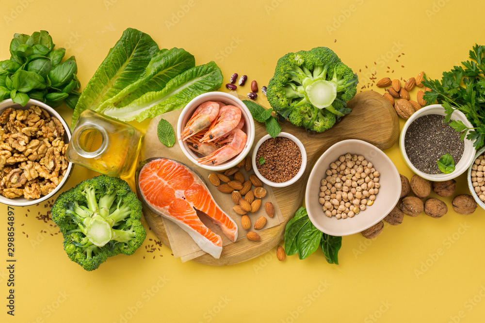 Omega 3 food sources and omega 6 on yellow background top view. Foods