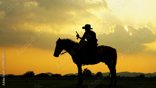 cowboy and horse at first light,mountain, river and lifestyle with natural light background 