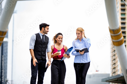 Business People Walking Together with hand holding book and folder at outdoor