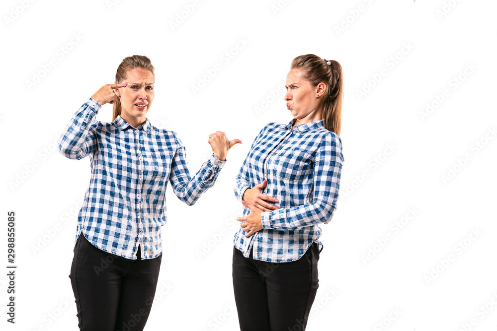 Young handsome woman arguing with herself on white studio background. Concept of human emotions, expression, mental issues, internal conflict, split personality. Half-length portrait. Negative space. Young handsome woman arguing with herself on white studio background. Concept of human emotions, expression, mental issues, internal conflict, split personality. Half-length portrait. Negative space.