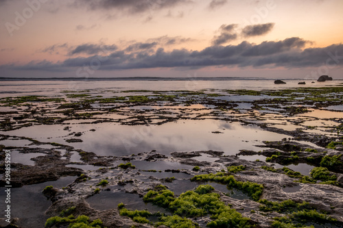 Seascape. Sunset at the beach. Ocean low tide. Horizontal background banner. Nyang Nyang beach  Bali  Indonesia.