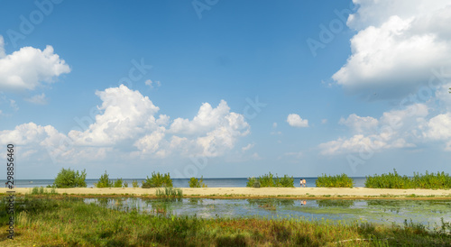 Scenic shot of Lake Superior in Saginaw, Michigan with two strangers entering the beach.
