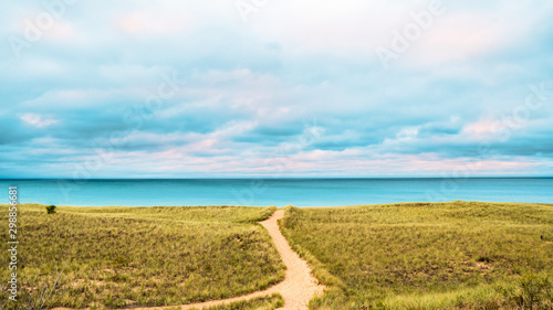 Single sandy path leading to lake michigan from the dunes