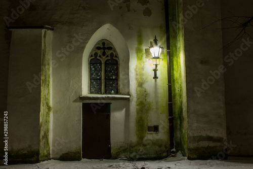 The door and window on the historic wall of Cathedral of Saint Mary the Virgin in Tallinn at night. Estonia