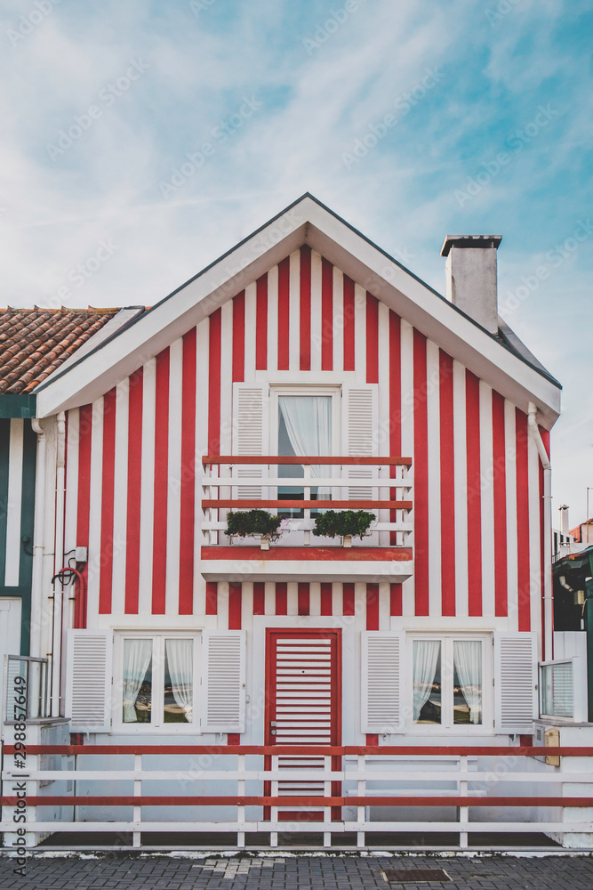 Red and white wooden striped houses in Costa Nova. Aveiro, Portugal
