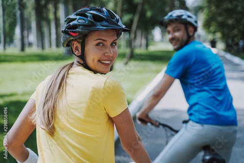 Fotografija Joyful woman enjoying bicycle ride with her husband