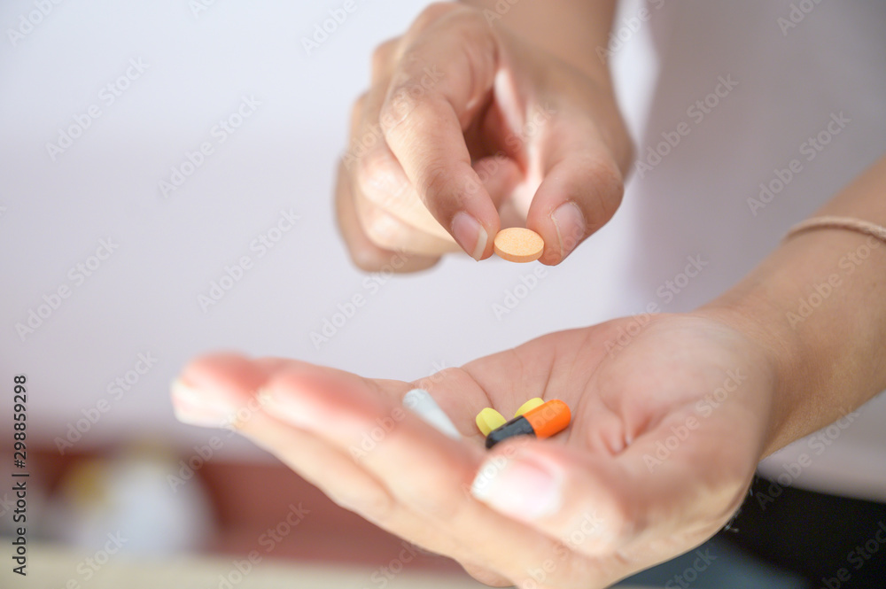 Various colored capsules placed in the hand Health care concept, capsule therapy, pharmaceutical industry, pharmacy Various colored capsules placed in the hand Health care concept, capsule therapy, pharmaceutical industry, pharmacy