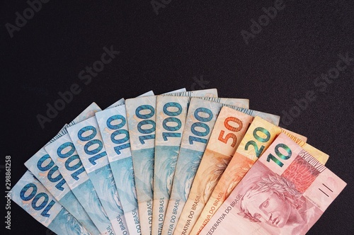 Brazilian money on black background. Real. Brazilian currency. 