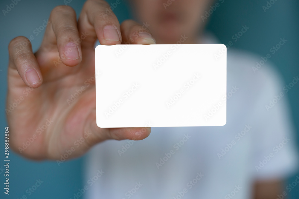 Hand holding a blank piece of paper. Close up white business card. Hand holding a blank piece of paper. Close up white business card.
