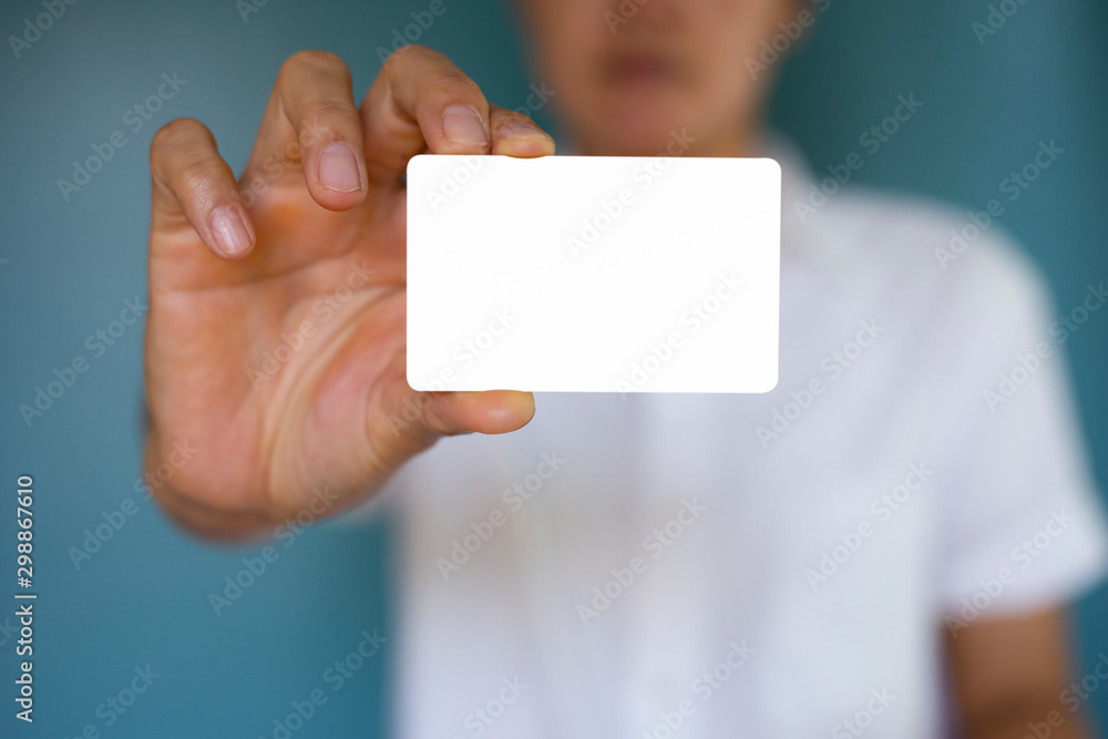 Hand holding a blank piece of paper. Close up white business card. Hand holding a blank piece of paper. Close up white business card.