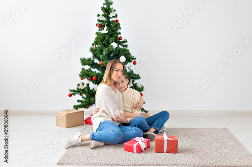 Single parent and holidays concept - Portrait of mother celebrating christmas at home on christmas eve