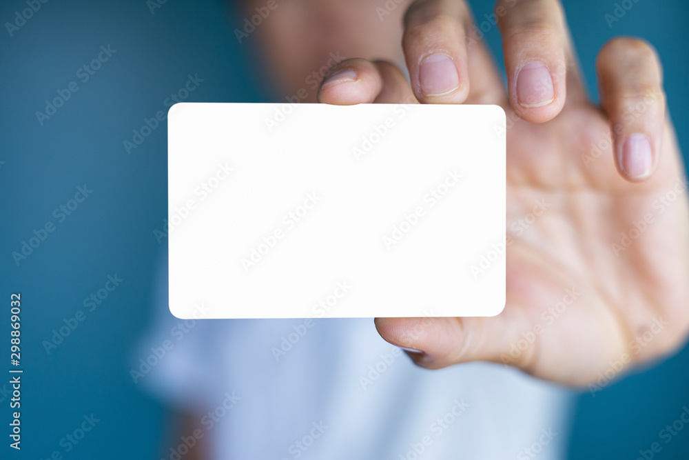 Hand holding a blank piece of paper. Close up white business card. Hand holding a blank piece of paper. Close up white business card.
