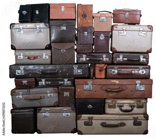 Big pile of vintage suitcases and leather boxes. Isolated on white background