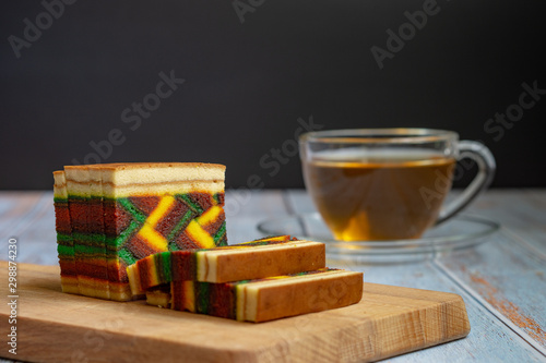 Malaysian dish "Kek Lapis Sarawak" or Sarawak layered cake over wooden background. Similar cake in Indonesia also known as "Kek Lapis Legit" or Legit Layerd Cake.