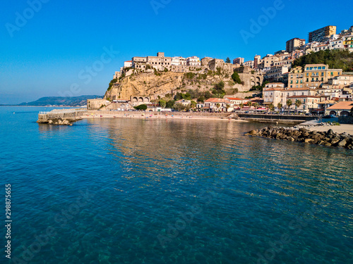 Fototapeta Naklejka Na Ścianę i Meble -  Aerial view of Pizzo Calabro, pier, castle, Calabria, tourism Italy. Panoramic view of the small town of Pizzo Calabro by the sea. Houses on the rock. On the cliff stands the Aragonese castle