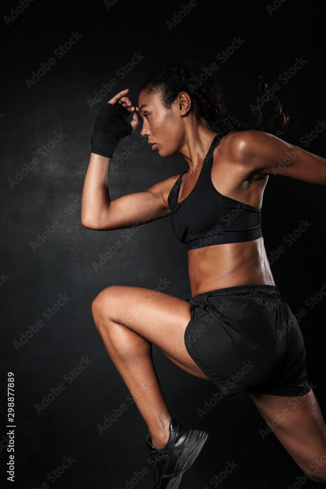 Obraz premium Image of african american woman in sportswear and hand wraps running