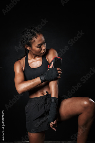 Image of athletic african american woman using mobile hand case © Drobot Dean