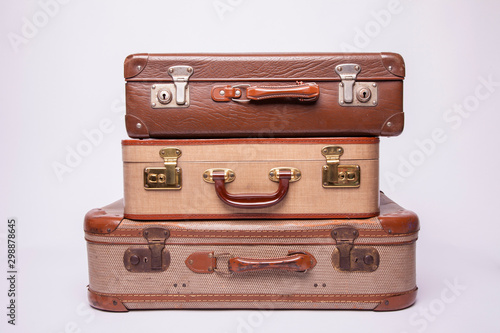 Old, retro, suitcases lie on the table with white background