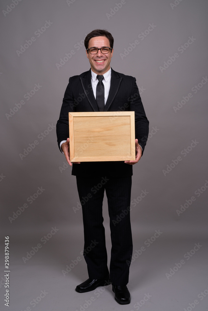 Full body shot of handsome Persian businessman in suit Full body shot of handsome Persian businessman in suit
