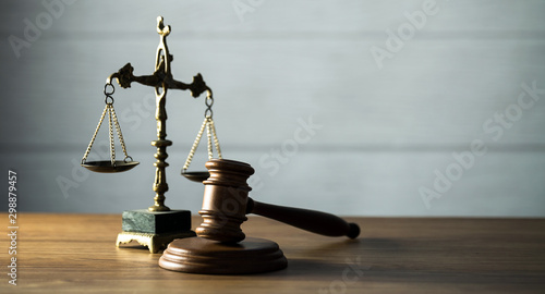 Wooden judge`s gavel. Themis figurine. The criminal law. Low concept.