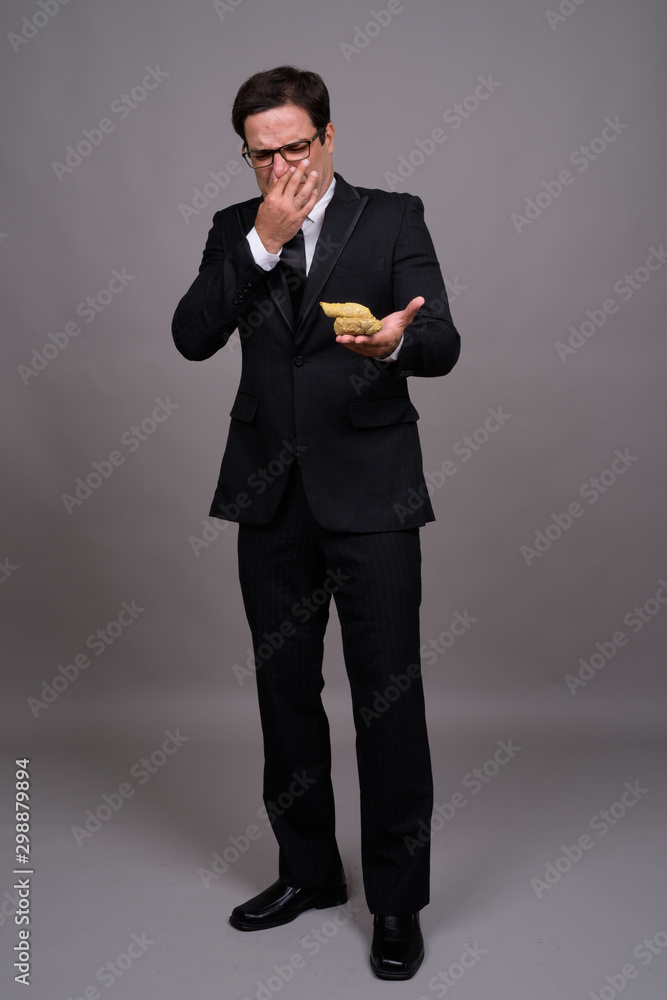 Full body shot of handsome Persian businessman in suit Full body shot of handsome Persian businessman in suit