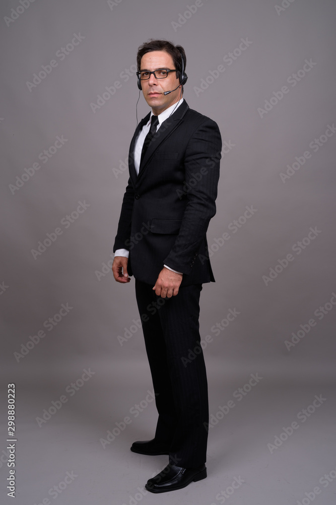 Handsome Persian businessman working as call center representati Handsome Persian businessman working as call center representati