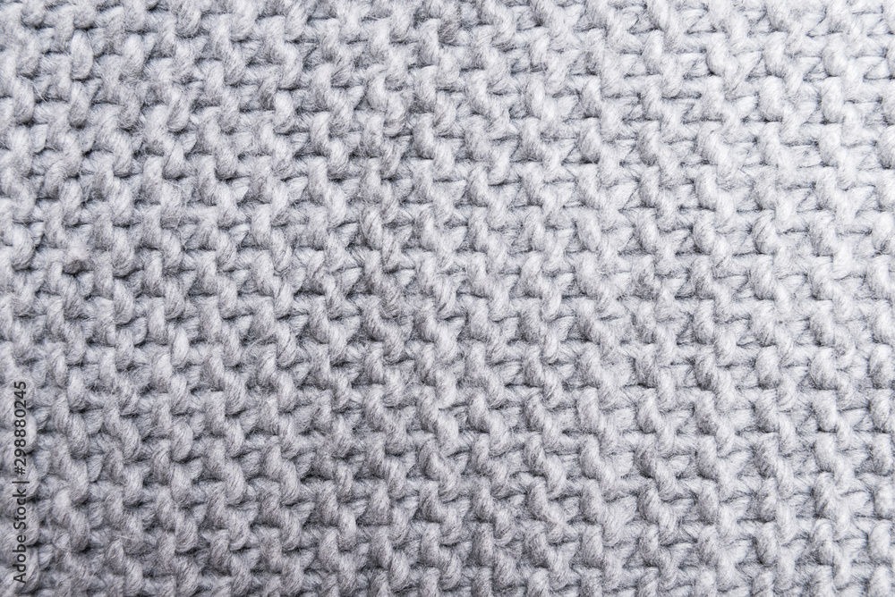 Gray knitted wool texture, pattern, background Gray knitted wool texture, pattern, background