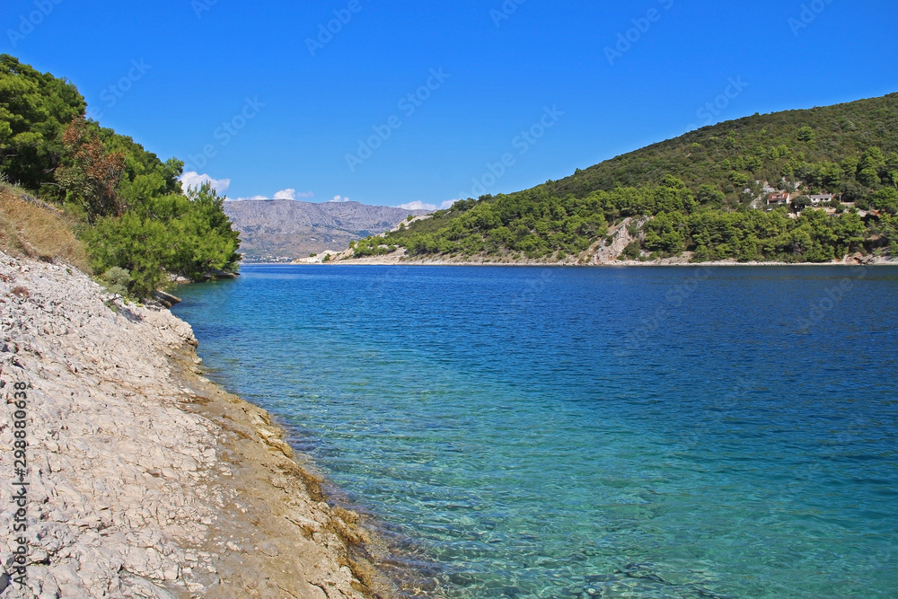 Fototapeta premium Beautiful landscape of sea Coast of Adriatic sea with Transparent Blue Water in Pucisca, Croatia. Island of Brac summertime.