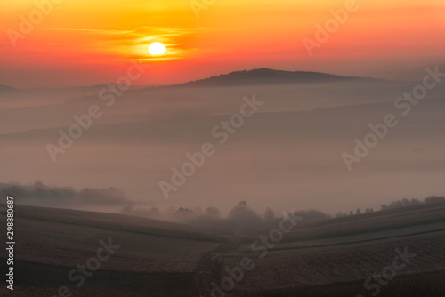 Moments after sunrise autumn mist over agriculture field 