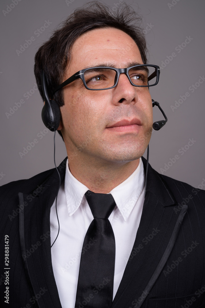 Handsome Persian businessman working as call center representati Handsome Persian businessman working as call center representati