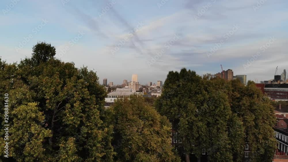 Raising up from behind a tree revealing Central London and Grey's Inn at sunset Raising up from behind a tree revealing Central London and Grey's Inn at sunset